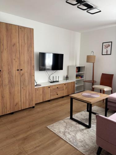a living room with a large entertainment center with a flat screen tv at Apartament Mirka centrum in Lidzbark Warmiński