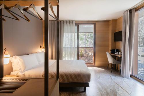 a bedroom with a four poster bed and a desk at Locanda Milia Etna in Ragalna