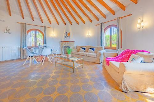 a living room with a couch and a table at Villa Ortembach- PlusHolidays in Ifach