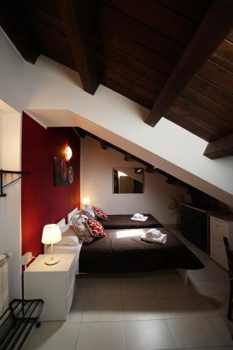 a bedroom with a black bed and a red wall at TERRA MIA in Città Giardino