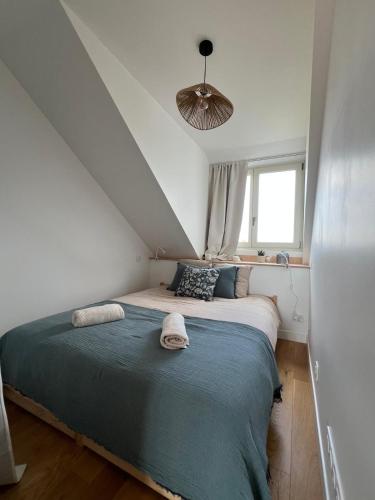 a bedroom with a large bed in a attic at Cozy studio in Cancale in Cancale