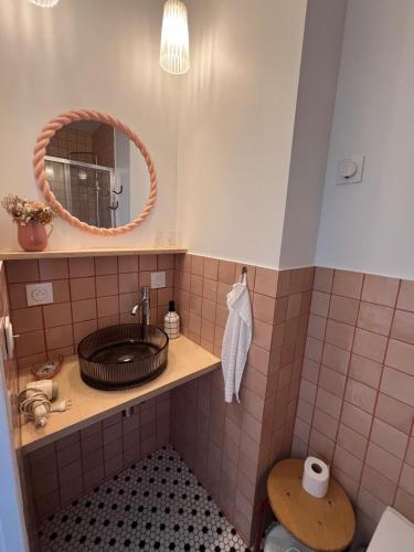 a bathroom with a sink and a mirror at Cozy studio in Cancale in Cancale