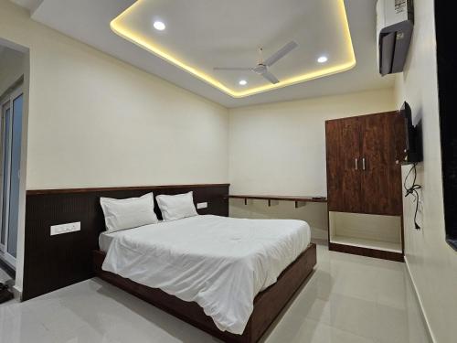 a bedroom with a bed and a television in it at AVON Homes in Jodhpur