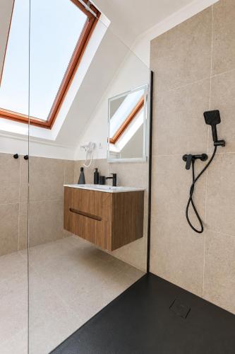 a bathroom with a sink and a shower at Marina Panzio in Siófok