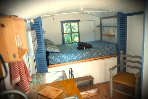 a small room with a bed in a house at Roulotte nature in Salernes