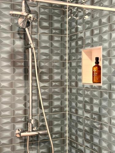 a shower with a bottle of whiskey on the wall at Apartments Paradise Hvar in Hvar