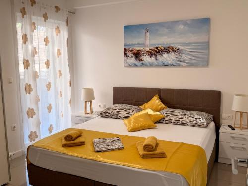 a bedroom with a bed with towels on it at Apartments Paradise Hvar in Hvar