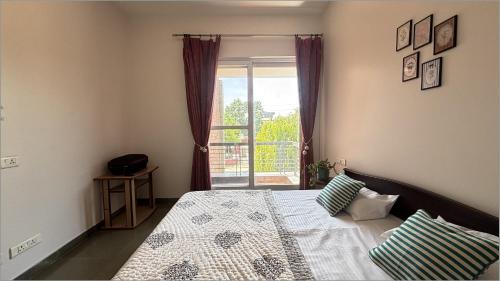 a bedroom with a large bed with a window at Red Brick House in Panchkula