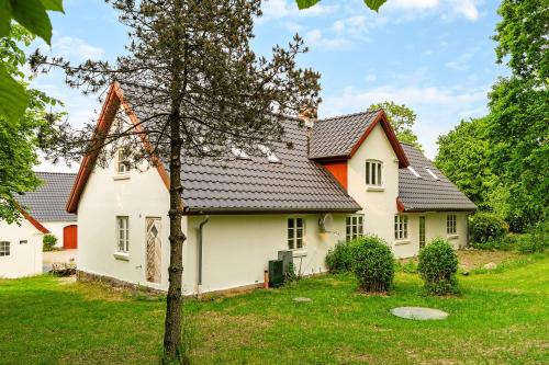 a white house with a black roof at The White Farm in Skanderborg