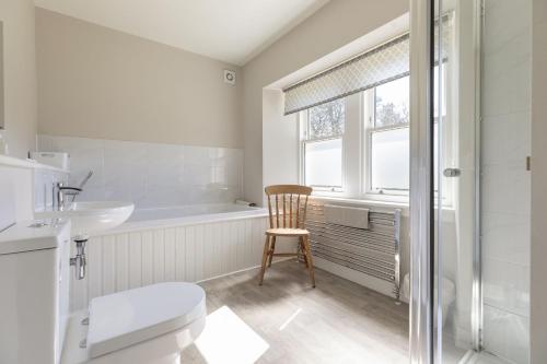 a bathroom with a toilet and a sink and a tub at Coldwells Farmhouse in Dalkeith