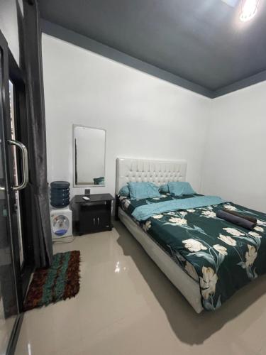 a bedroom with a bed and a mirror at AFWA Surf and Stay in Selong Belanak