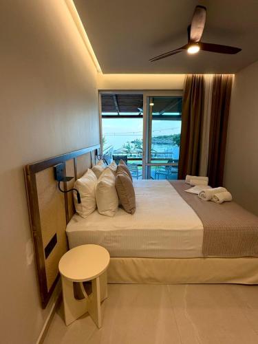 a bedroom with a large bed with a window at Houmas Apartments in Palaiochora