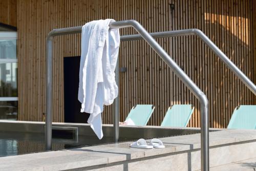 a towel hanging on a rail next to some chairs at Selma Spa in Sunne