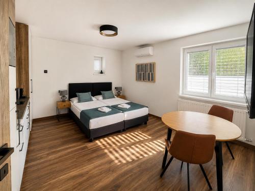 a bedroom with a bed and a table in it at IQ Apartments in Prešov
