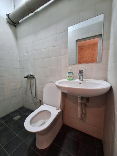 a bathroom with a toilet and a sink at Baku apart in Baku