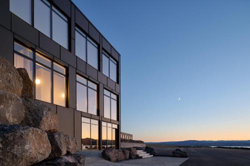 a building with large windows on the side of it at Black Sand Hotel in Ölfus