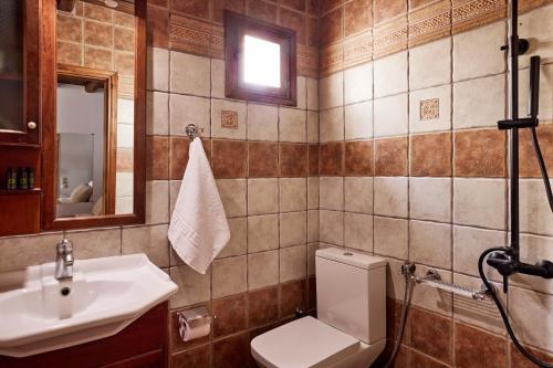 a bathroom with a toilet and a sink at Infinito Boathouse Milos in Agia Irini Milos