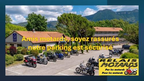 a group of motorcycles parked in a parking lot at Kyriad Digne-Les-Bains in Digne-les-Bains
