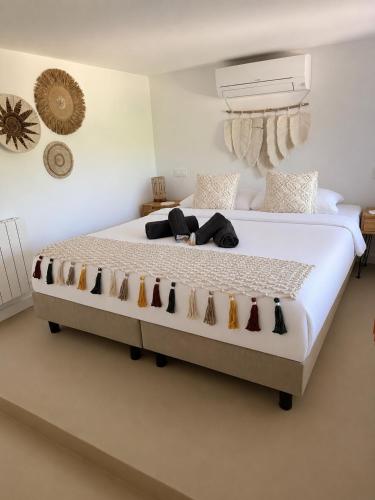 a bedroom with a large bed with cats on it at Villa Mirella in Jávea