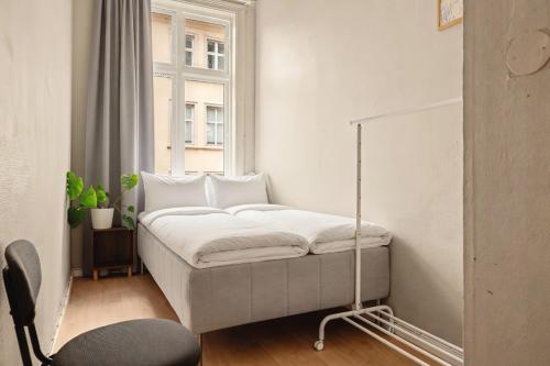 a bed in a room with a window at Bergen Guesthouse in Bergen