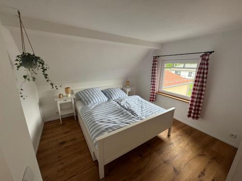 a bedroom with a bed and a window at Schlosserhäuschen in Leipzig
