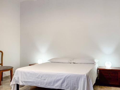 a white bed with two white pillows on it at Allombra della quercia in Ortona