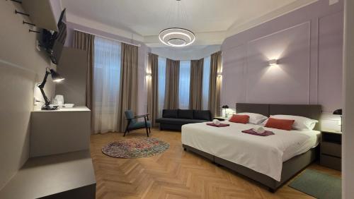 a bedroom with a large bed and a couch at Apartment & Rooms Three Angels in Baška