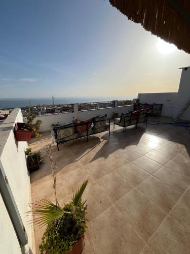 a balcony with benches and a view of the ocean at Atlantic view Tamraght 1 in Tamraght Ou Fella