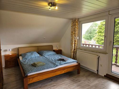 a bedroom with a bed and a large window at Ferienwohnung "Haggi" 35672 in Uplengen