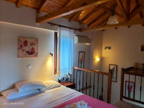 a bedroom with a bed and a window at Steni Vala Apartments in Steni Vala Alonissos