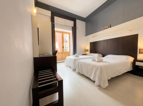 a bedroom with two beds and a window at Alhambra Suites in Madrid
