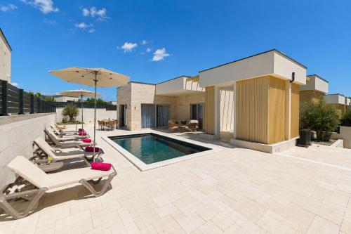 a patio with lounge chairs and a swimming pool at Villa Stone in Smoković