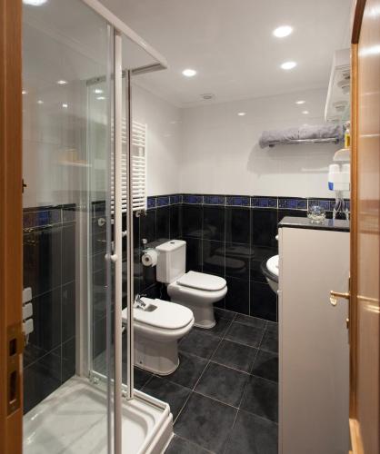a bathroom with two toilets and a shower at Pensión San Lorenzo in Nájera