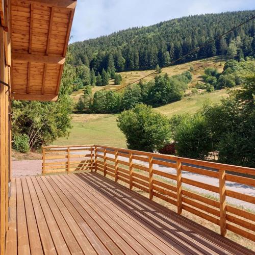 a wooden deck with a view of a mountain at Chalet Les Noisetiers in Rochesson