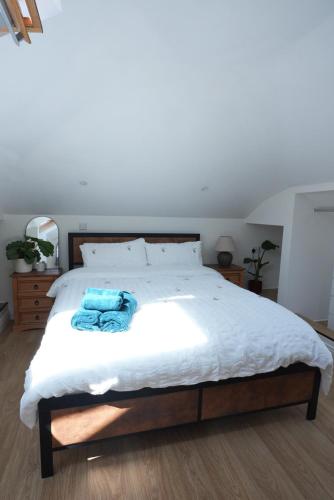 a bedroom with a bed with a blue towel on it at Steps to the Sand in Melcombe Regis