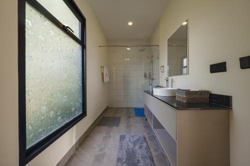 a bathroom with a sink and a large window at Pods at Aloe Valley, Ngobit Laikipia in Gatunga