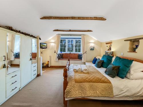 a bedroom with a large bed and a window at The Coach House Dulverton in Dulverton