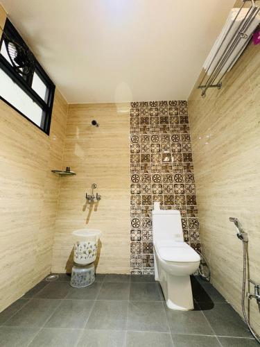 a bathroom with a toilet and a sink at La Casa Residency in Lucknow