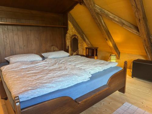a bedroom with a large bed in a attic at Glücksschmiede Hennersdorf in Dippoldiswalde