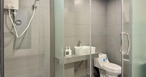 a bathroom with a shower and a toilet and a sink at WH302 Residence by WH in Phnom Penh
