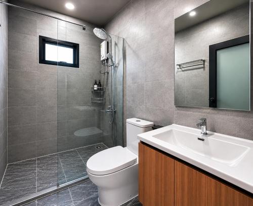 a bathroom with a toilet and a sink and a shower at Ranong Adventure Resort & Park in Ranong