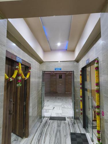 a hallway in a building with doors and a ceiling at Gopal Dham in Govardhan