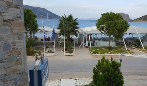 a view of a building with a street and the ocean at Sea Sight Boutique Hotel in Porto Rafti