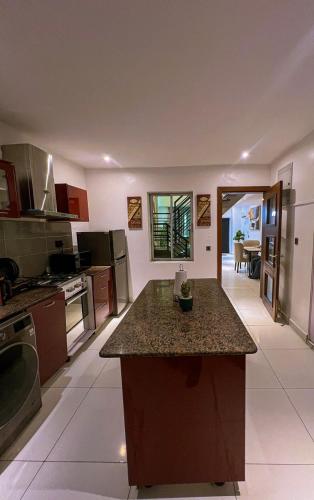 a large kitchen with a island in the middle at Abbey's Home in Ogoyo