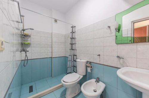 a bathroom with a toilet and a sink at Lika's Residence in Golem