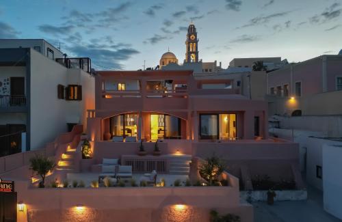 a view of a house with a clock tower at Thianne Luxury Suites in Fira