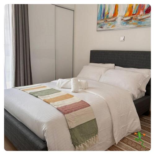 a bedroom with a bed with a quilt on it at The Quiet Creative, Corporate-Ready 1BR in Tatu City