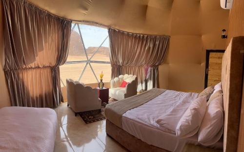a bedroom with a bed and a large window at Magic rum hussen Luxury in Wadi Rum