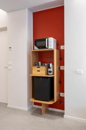 a microwave on a shelf in a room at Velino Business Suite in Avezzano