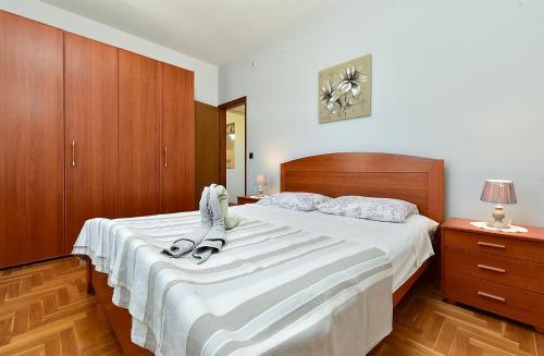 a bedroom with a large bed with shoes on it at House Pavicini 333 in Pavicini